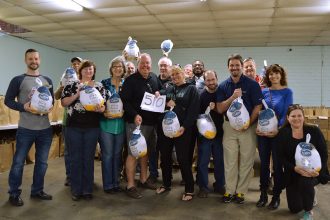 A group of Salvation Army volunteers led by Miracle-on-the-Hudson plane crash survivor Casey Jones, center, distributes turkeys at Thanksgiving time. In 2016, Jones collected 510 turkeys.