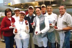 Volunteers from Lakewood Presbyterian Church meal group, which has consistently served since 1999, get ready to serve in the Sulzbacher Center kitchen.