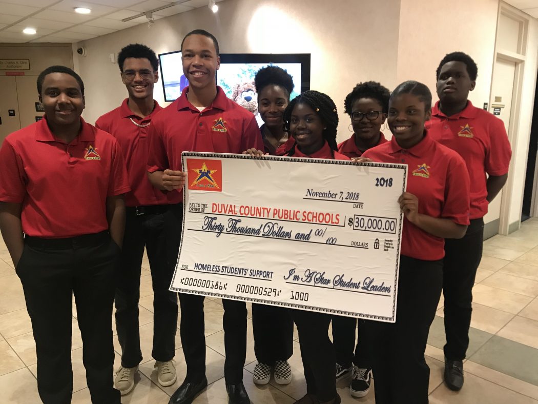 Teen servant leaders, ages 13-18, in I'm A Star Foundation presented a check for $30,000 before the Duval County Public School Board Nov. 7.