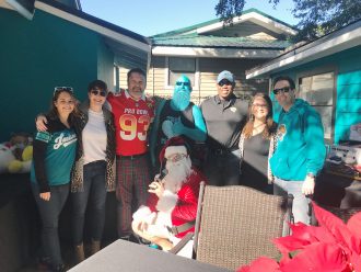 Sarah Stec and Courtney Weatherby-Hunter with Children's Home Society, Attorney John Phillips, Teal Man, and Kevin Copeland, CHS board member with Jessica Henderson and Dave Cognetta, of CHS...and Santa!