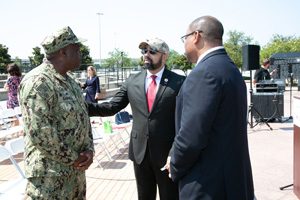 U.S. Navy Commander James M. Carroll visits with Koby J. Langley, senior vice president for the Service to the Armed Forces Division of the American Red Cross, and Bill Bradley, vice president of community affairs, Anheuser-Busch.