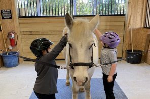 two masked children petting animal | North Florida School for Special Education (NFSSE)
