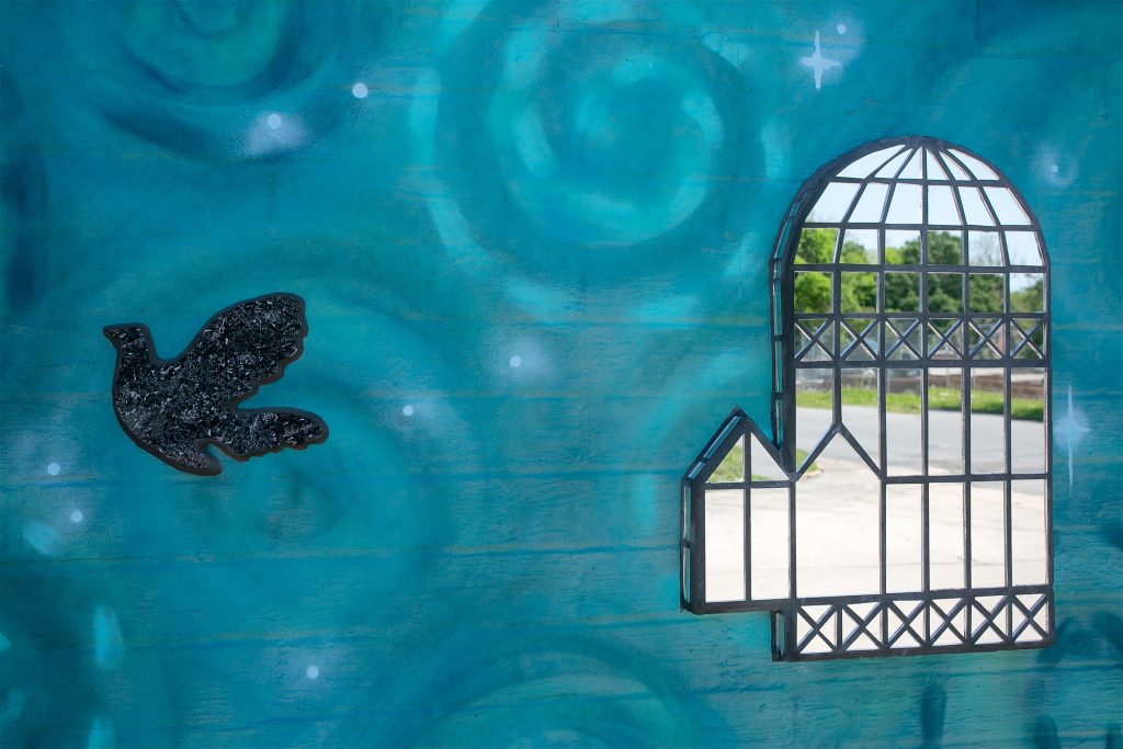 mural of bird and a mirrored birdcage