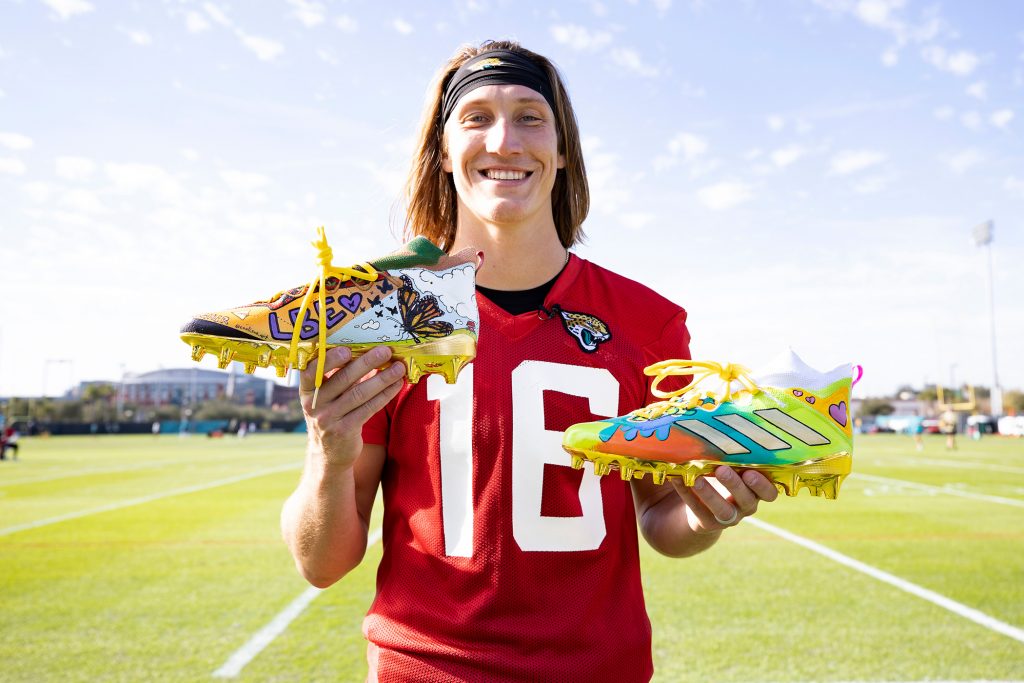 Trevor Lawrence with donated cleats to benefit Eastside school.